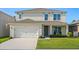 Charming two-story home with a well-maintained lawn and attached two-car garage at 5386 Pine Lilly Dr, St Cloud, FL 34771