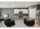 Large kitchen island with barstool seating, granite counters, and white cabinets at 5386 Pine Lilly Dr, St Cloud, FL 34771