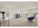Open loft area with carpet, large windows for natural light, and comfortable seating; ideal for relaxing at 5386 Pine Lilly Dr, St Cloud, FL 34771