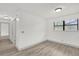 Bright bedroom features wood-look floors, a window, and neutral paint at 5390 Nw 12Th Pl, Ocala, FL 34482