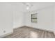 Bedroom features wood-look flooring, a ceiling fan, and a window at 5390 Nw 12Th Pl, Ocala, FL 34482