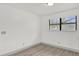 Bright, minimalist bedroom with wood-look floors and neutral paint at 5390 Nw 12Th Pl, Ocala, FL 34482