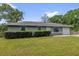 Charming one-story home with a well-manicured lawn and mature landscaping at 5390 Nw 12Th Pl, Ocala, FL 34482