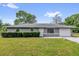 Charming one-story home with a well-manicured lawn and mature landscaping at 5390 Nw 12Th Pl, Ocala, FL 34482
