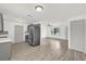 Open kitchen and living space with stainless steel appliances and hardwood floors at 5390 Nw 12Th Pl, Ocala, FL 34482