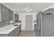 Updated kitchen featuring stainless appliances, grey tile back splash, and white counter tops at 5390 Nw 12Th Pl, Ocala, FL 34482