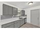 Updated kitchen with gray cabinets, stainless steel appliances, and a gray subway tile backsplash at 5390 Nw 12Th Pl, Ocala, FL 34482