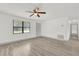 Light filled living space with wood look flooring and ceiling fan at 5390 Nw 12Th Pl, Ocala, FL 34482