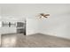 Open-concept kitchen and living area with modern gray cabinetry and stainless steel appliances at 5390 Nw 12Th Pl, Ocala, FL 34482