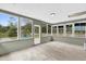 Enclosed sunroom featuring large windows and natural light at 5390 Nw 12Th Pl, Ocala, FL 34482