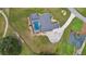 Drone eye view showcases the home's large yard, driveway and screened pool with a peek into the pool's refreshing water at 5429 County Road 125, Wildwood, FL 34785