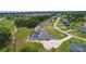 Expansive single-story home boasts a screened pool, neutral palette, and sprawling manicured lawn in a golf community at 5429 County Road 125, Wildwood, FL 34785