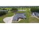 Attractive home showcasing a screened pool and lush yard in a golf course community with scenic water features at 5429 County Road 125, Wildwood, FL 34785