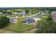 Beautiful home featuring a screened pool and spacious lawn in a community with lakes, abundant trees, and inviting streets at 5429 County Road 125, Wildwood, FL 34785