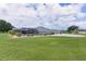 The large backyard of this beautiful home features plenty of green space and a screened in pool at 5429 County Road 125, Wildwood, FL 34785