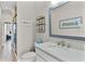 Stylish bathroom featuring a modern vanity, beach-themed decor, and a convenient walk-in shower at 5429 County Road 125, Wildwood, FL 34785