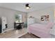 Bright bedroom with a ceiling fan, desk area and decorative accents at 5429 County Road 125, Wildwood, FL 34785