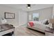 Inviting bedroom features wood-look flooring and a window offering natural light at 5429 County Road 125, Wildwood, FL 34785