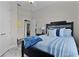 Comfortable bedroom featuring a stylish bed with blue accents and ample natural light for a serene ambiance at 5429 County Road 125, Wildwood, FL 34785