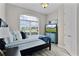 Cozy bedroom featuring a large window, comfortable bed, and stylish blue accents for a relaxing retreat at 5429 County Road 125, Wildwood, FL 34785