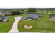 Attractive single-story house with a well-manicured front yard, long driveway, and thoughtfully designed landscaping at 5429 County Road 125, Wildwood, FL 34785