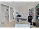 Bright home office with a stylish desk and glass doors, offering a serene and productive workspace at 5429 County Road 125, Wildwood, FL 34785