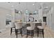 Kitchen showcasing bar seating, stone countertops, stainless appliances, and view into living room at 5429 County Road 125, Wildwood, FL 34785