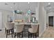 Kitchen bar seating at a white countertop island, with light cabinetry and stainless appliances at 5429 County Road 125, Wildwood, FL 34785