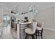 Kitchen featuring an island with bar seating and light-colored cabinetry with stone countertops at 5429 County Road 125, Wildwood, FL 34785