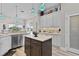 Bright kitchen featuring pendant lighting, stainless steel appliances, and an island with white countertop at 5429 County Road 125, Wildwood, FL 34785