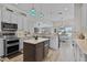 Spacious kitchen with stainless steel appliances, double oven, and center island next to breakfast nook at 5429 County Road 125, Wildwood, FL 34785