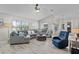 Open living room featuring sectional seating, a ceiling fan, and access to the dining area at 5429 County Road 125, Wildwood, FL 34785