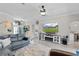 Inviting living room showcasing a large TV, fireplace, and comfortable seating at 5429 County Road 125, Wildwood, FL 34785