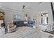 Spacious living room with a comfortable seating arrangement, ceiling fan, and entryway at 5429 County Road 125, Wildwood, FL 34785