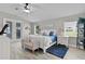 Bright main bedroom featuring a king bed, French doors, and a calming coastal decor for a serene escape at 5429 County Road 125, Wildwood, FL 34785