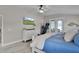 Spacious main bedroom featuring a king bed, television, and French doors leading to a private outdoor space at 5429 County Road 125, Wildwood, FL 34785