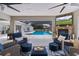 Entertain guests in the covered patio with an outdoor kitchen, stone fireplace and comfortable outdoor seating at 5429 County Road 125, Wildwood, FL 34785