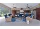 Inviting covered patio with ample seating, an outdoor kitchen, and views of the lush backyard at 5429 County Road 125, Wildwood, FL 34785