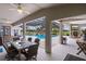 Spacious covered patio with dining and seating areas overlooking screened pool at 5429 County Road 125, Wildwood, FL 34785