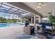 Spacious covered patio overlooking a screened pool and lush backyard at 5429 County Road 125, Wildwood, FL 34785