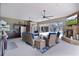Entertain in the beautiful patio space with a kitchen, stone fireplace, tv, and comfortable outdoor seating at 5429 County Road 125, Wildwood, FL 34785