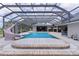Beautiful pool with slide surrounded by an enclosure providing shade and pest control at 5429 County Road 125, Wildwood, FL 34785