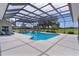 Enclosed pool area features a slide, waterfall feature, and ample deck space for lounge chairs and outdoor entertainment at 5429 County Road 125, Wildwood, FL 34785