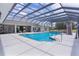 Screened pool and outdoor living area perfect for year round fun, with water features, slide, and ample space at 5429 County Road 125, Wildwood, FL 34785