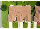 Aerial view of a well-maintained home with a brown roof and lush green lawn at 5512 Rosewall Cir, Leesburg, FL 34748