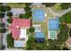 Aerial view displaying community amenities, including tennis courts, pool, and ample parking at 5512 Rosewall Cir, Leesburg, FL 34748