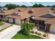 Beautiful home featuring meticulously maintained landscaping, sidewalks, and an American flag at 5512 Rosewall Cir, Leesburg, FL 34748