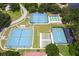 An aerial view showcases tennis courts and other recreational facilities for community enjoyment at 5512 Rosewall Cir, Leesburg, FL 34748
