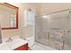 Cozy bathroom with tiled shower, ample lighting, vanity, and a decorative mirror at 5512 Rosewall Cir, Leesburg, FL 34748
