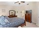 Bedroom with ceiling fan, plush carpet, and stylish wood dresser at 5512 Rosewall Cir, Leesburg, FL 34748
